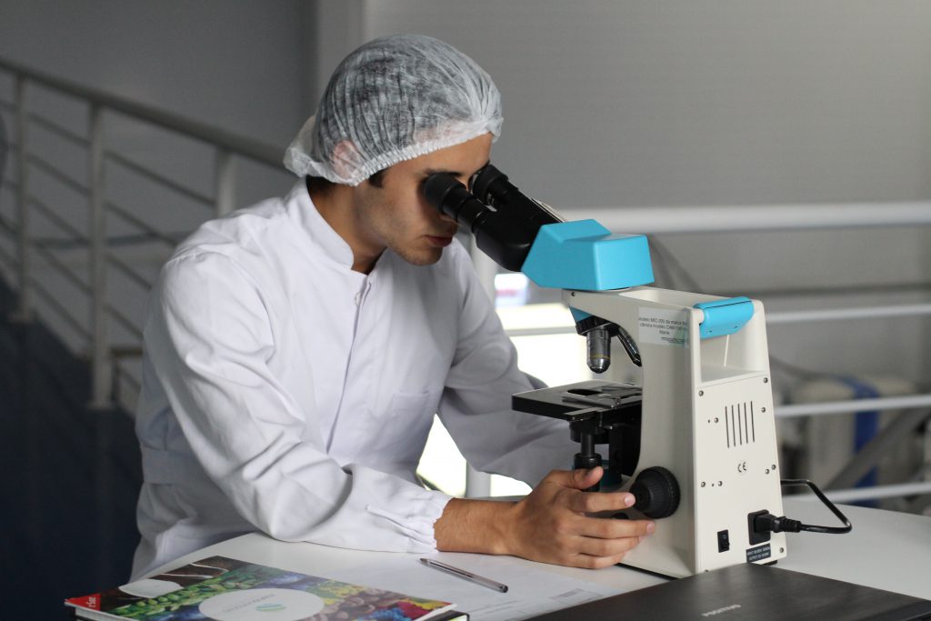 Scientist using microscope in laboratory